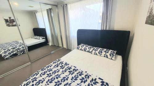 a bedroom with a bed and a mirror at Timeless Tranquility in Belconnen
