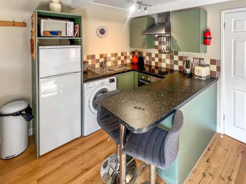 a kitchen with green cabinets and a counter top at Dragonfly One in North Newton