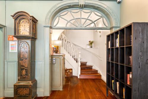 a room with a staircase and a grandfather clock at Casa dos Lóios by Shiadu in Porto