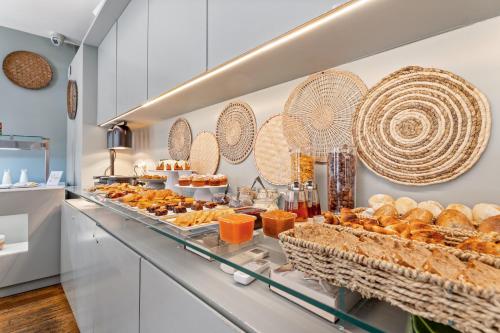 a buffet line with bread and pastries on display at Casa dos Lóios by Shiadu in Porto