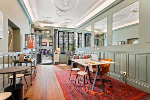 a restaurant with tables and chairs and a rug at Casa dos Lóios by Shiadu in Porto