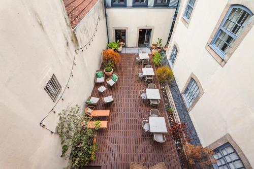 an overhead view of a patio with tables and chairs at Casa dos Lóios by Shiadu in Porto