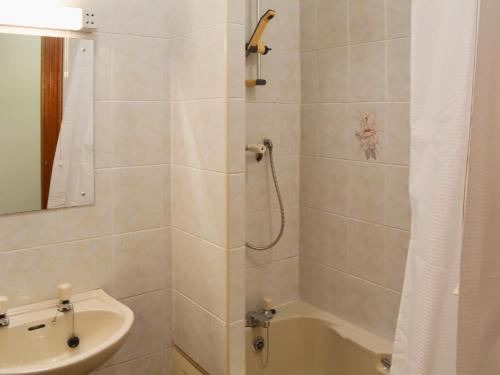 a bathroom with a shower and a sink at Glan-Mor in Pwllheli