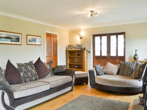 a living room with a couch and two couches at Chapel House in Dearham