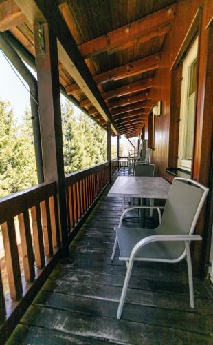 a porch with a table and chairs on it at Chillpartments Black Forest in Feldberg