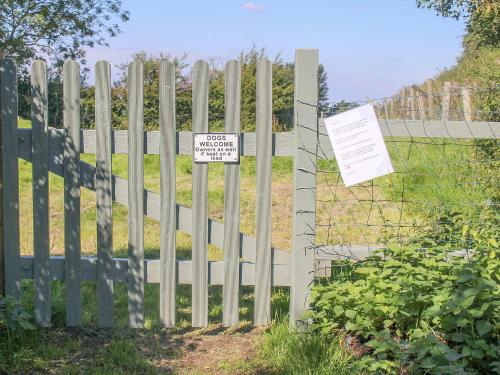 a fence with a sign that says no trespassing on it at Bellwood House Annexe in Felixkirk