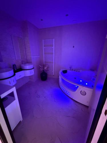 a purple bathroom with a tub and two toilets at Maison Frappaz in Villeurbanne