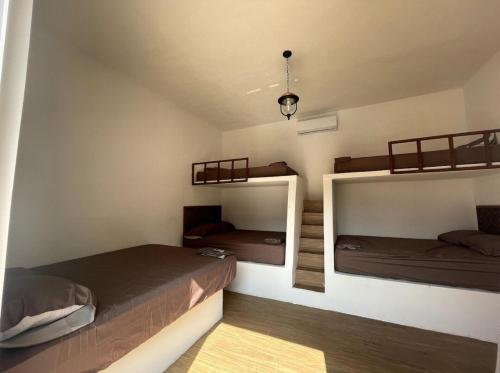 a room with three bunk beds in it at Villa Los Delfines 2 in Monterrico