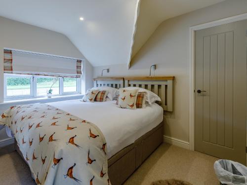 a bedroom with a large bed with fish patterned sheets at The Grousemoor in Llandegla