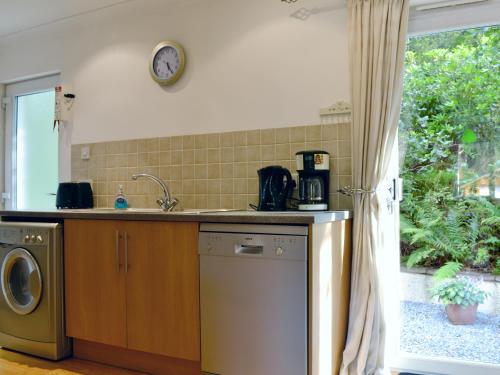 a kitchen with a sink and a dishwasher at Lia Fail in Ballachulish