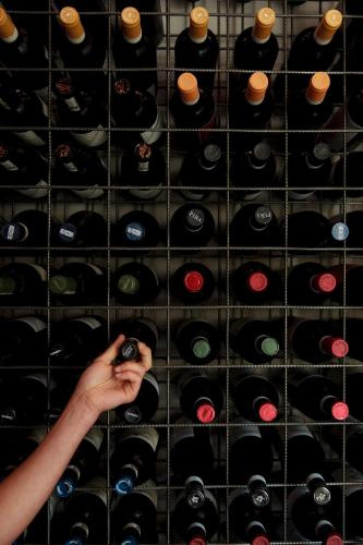 a wall of wine bottles in a wine cellar at Réva Resort in Monforte dʼAlba