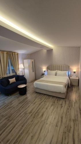a large bedroom with a large bed and a couch at Chalet--JS--شاليه in Hatta