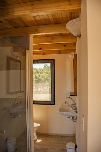 a bathroom with two sinks and a window at Senador Dupont- Convento San Francisco & Arboles in Tigre