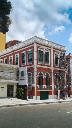 a red brick building on the corner of a street at JUNGLE STATION - Hostel in Belém