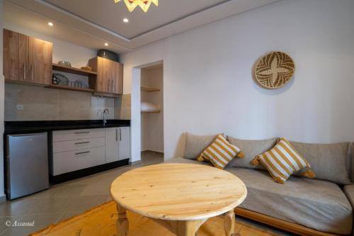 a living room with a couch and a table at Vista Verde in Oulad Akkou
