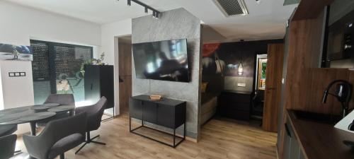 a kitchen with a table and a dining room at R73 Residences in Pécs
