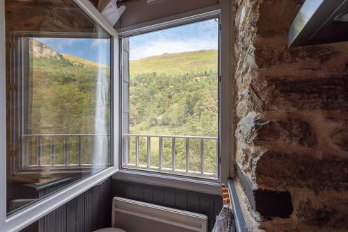 a window with a view of a mountain at Appartement de charme T2 en RDC in Eaux-Bonnes