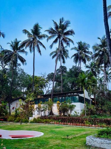 a resort with palm trees in the background at Indulge House in Revora