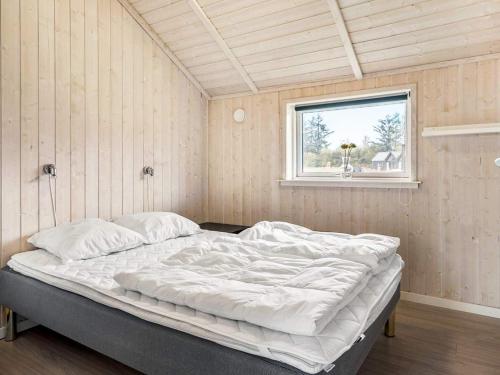 a large bed in a room with a window at Luxury Lakeside Retreat - By Traum Ferienwohnungen in Ansager