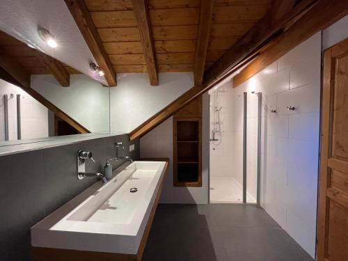a bathroom with a sink and a shower at Chalet Oz ski-in ski-out in Oz