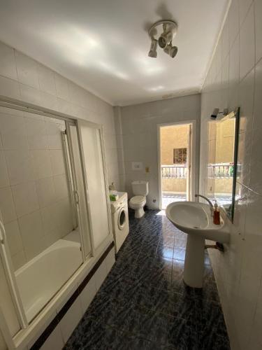 a bathroom with a sink and a shower and a toilet at Villa Maadi 35 -R 101- Terrace View Room in Cairo