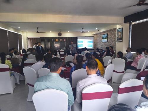 a group of people sitting in a room watching a presentation at Aliza Inn And Suites By SRS Hotels in Dharamshala