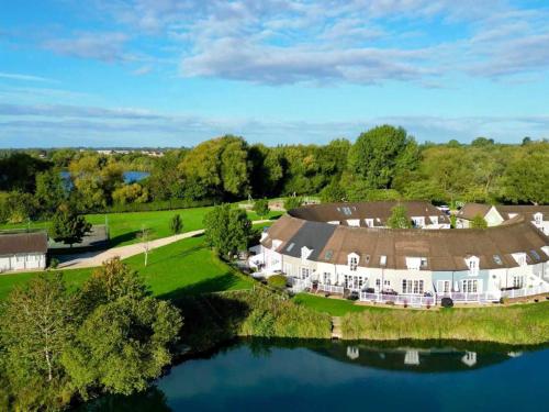 an aerial view of a large estate with a lake at Isis Lakes 09, ArtHouse in South Cerney