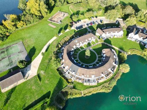 an aerial view of a park with a lake at Isis Lakes 09, ArtHouse in South Cerney