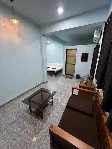a living room with a couch and a table at Beach Side Home Stay - Kihim in Kīhīm
