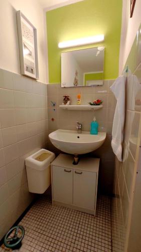 a small bathroom with a sink and a toilet at Up'N'Down - Rooms in Nuremberg