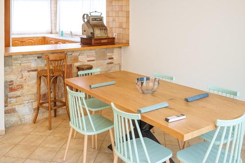 a kitchen with a wooden table and chairs at Mulberry House by the Sea Νέα Μάκρη in Nea Makri