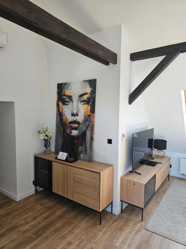 a living room with a large painting on the wall at Apartamenty SWAN in Gliwice