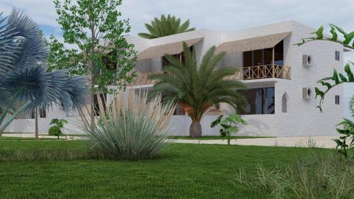 a house with a palm tree in front of it at Kipepeo Beach and Village in Dar es Salaam