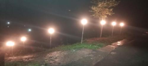 a row of lights on a road at night at Thulasitharayil in Vagamon