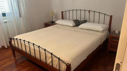 a bed with two pillows on it in a bedroom at il campanile in Gaeta
