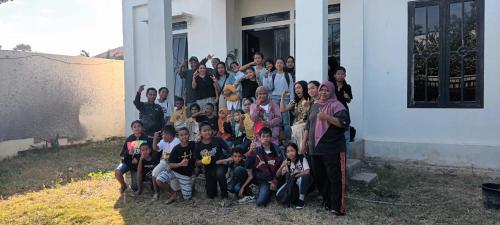 a group of people posing in front of a building at Sony homestay in Komodo Labuan Bajo Airport