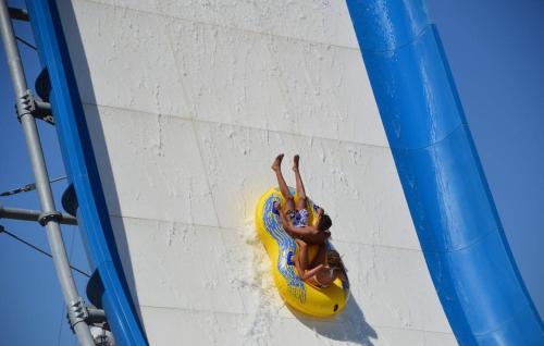 a woman is on a ride in a pool at DRIL Host 1 in Brindisi