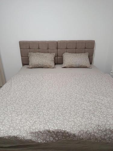 a bed with two pillows on top of it at Bili 3 in Paraćin