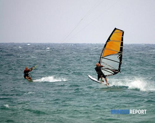 two men are wind surfing in the ocean at DRIL Host 1 in Brindisi