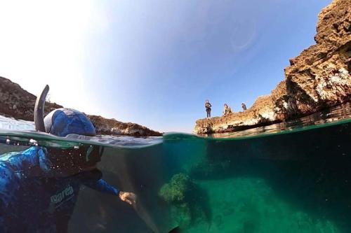 a person in the water with a surfboard in the ocean at DRIL Host 1 in Brindisi