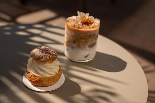 a table with two pastries and a drink on it at Hotel Muchele in Postal
