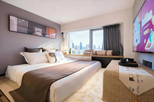 a bedroom with a large bed and a large window at Yushe International Hotel - Pazhou Convention and Exhibition Center, Haizhu District, Guangzhou - Exclusive for the Canton Fair in Guangzhou