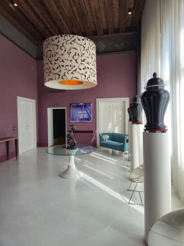 a living room with a glass table and purple walls at Sina Centurion Palace in Venice