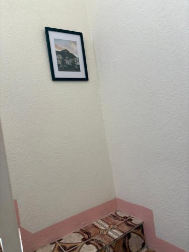 a picture hanging on a wall in a room at Blissful Oasis by Castle Adora in Tower Isle