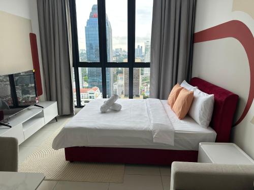 a bedroom with a bed and a large window at Ubays Majestic House in Kuala Lumpur