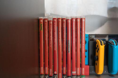 a row of books sitting on a shelf with scissors at 松島雅居 in Tokyo