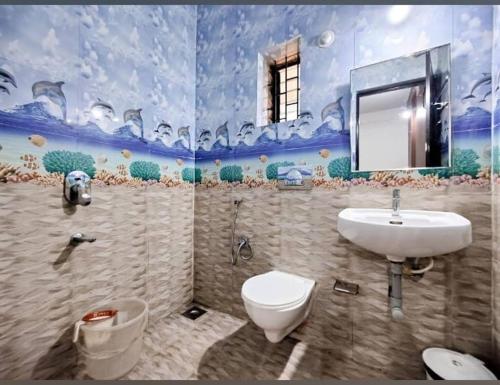 a bathroom with a sink and a toilet at Pasquina guest house in Calangute