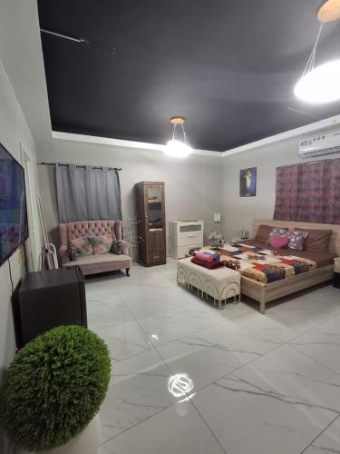 a living room with a bed and a couch at Cozy Corner 2024 in Abu Dhabi