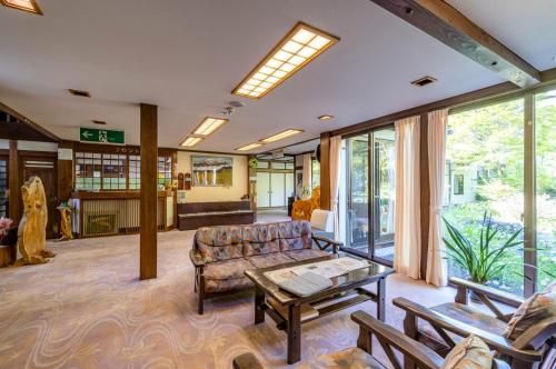 a living room with a couch and a table at Yaki no Yu - Vacation STAY 29804v in Takayama