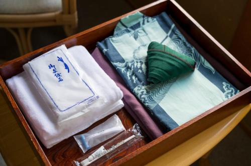 a wooden box filled with towels and towels at Yaki no Yu - Vacation STAY 29804v in Takayama